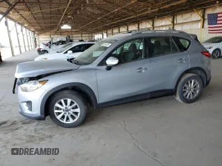 2016 Mazda CX-5 Sport with VIN JM3KE2BEXG0620533, listed as a Copart auction lot 58994295 with 129,474 mi miles and Salvage title. Bid and sale history available at DreamBid. Image 1.