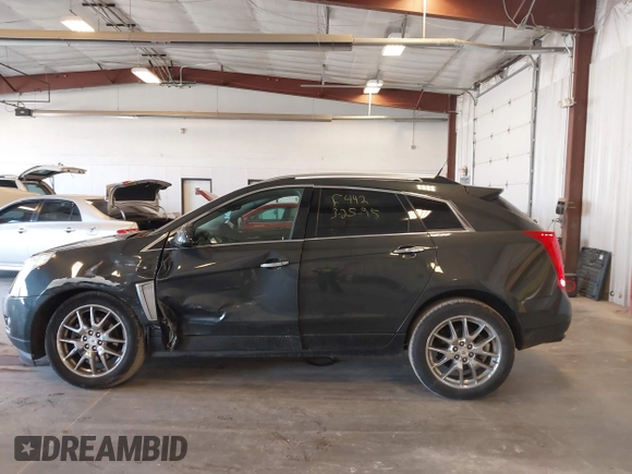 2014 Cadillac SRX Premium Collection z VIN 3GYFNGE38ES606731, wystawiony jako IAAI lot #41844450 z przebiegiem 156 541 mil mil oraz . Historia ofert i sprzedaży dostępna na DreamBid. Obrazek 14.