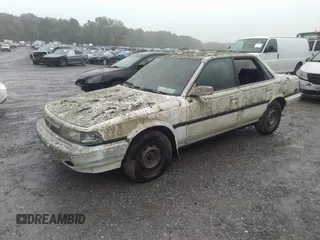 1991 Toyota Camry z VIN 4T1SV22E1MU450491, wystawiony jako IAAI lot #40356634 z przebiegiem 285 677 mil mil oraz . Historia ofert i sprzedaży dostępna na DreamBid. Obrazek 2.