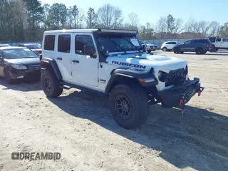 2022 Jeep Wrangler Unlimited Rubicon z VIN 1C4JJXFGXNW121489, wystawiony jako IAAI lot #41749550 z przebiegiem 56 601 mil mil oraz . Historia ofert i sprzedaży dostępna na DreamBid. Obrazek 1.