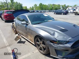 2021 Ford Mustang EcoBoost z VIN 1FA6P8TH3M5100601, wystawiony jako IAAI lot #42060948 z przebiegiem 79 677 mil mil oraz . Historia ofert i sprzedaży dostępna na DreamBid. Obrazek 1.