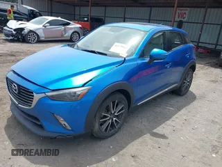 2016 Mazda CX-3 Grand Touring z VIN JM1DKFD78G0134173, wystawiony jako IAAI lot #42179942 z przebiegiem 93 539 mil mil oraz . Historia ofert i sprzedaży dostępna na DreamBid. Obrazek 2.
