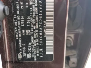2013 Kia Optima LX z VIN 5XXGM4A7XDG129700, wystawiony jako Copart lot #47581035 z przebiegiem 121 247 mil mil oraz Szkody całkowita. Historia ofert i sprzedaży dostępna na DreamBid. Obrazek 14.