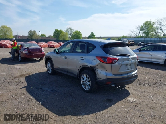 2014 Mazda CX-5 Grand Touring with VIN JM3KE4DY7E0311893, listed as a IAAI auction lot 42090872 with 102,154 mi miles and . Bid and sale history available at DreamBid. Image 3.
