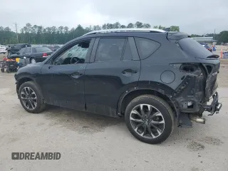 2016 Mazda CX-5 Grand Touring z VIN JM3KE2DY5G0676290, wystawiony jako Copart lot #54155325 z przebiegiem 124 743 mil mil oraz Szkoda całkowita • Salvage title. Historia ofert i sprzedaży dostępna na DreamBid. Obrazek 2.