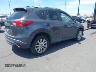 2014 Mazda CX-5 Grand Touring with VIN JM3KE4DY8E0391317, listed as a IAAI auction lot 41871641 with 77,048 mi miles. Bid and sale history available at carsss.com. Image 4.