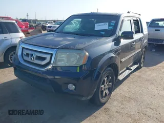 2011 Honda Pilot Touring with VIN 5FNYF4H92BB090056, listed as a IAAI auction lot 42010682 with 201,640 mi miles. Bid and sale history available at carsss.com. Image 2.