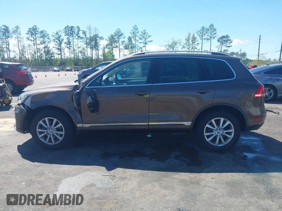 2014 Volkswagen Touareg Sport with VIN WVGEF9BP7ED003525, listed as a IAAI auction lot 41868307 with 74,379 mi miles and . Bid and sale history available at DreamBid. Image 14.