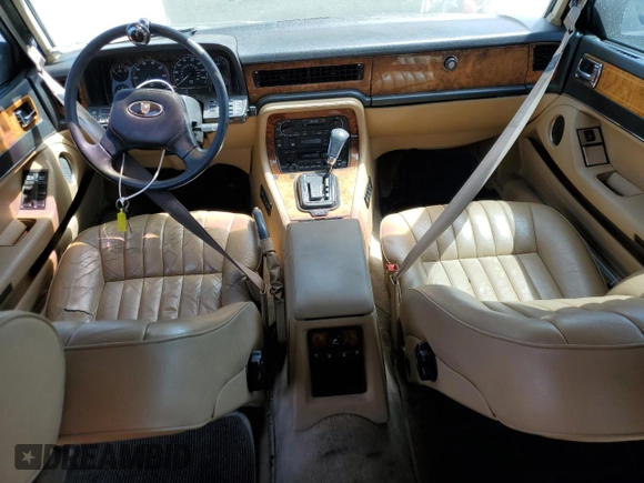 1992 Jaguar XJ with VIN SAJHY174XNC649368, listed as a Copart auction lot 50191454 with 99,553 mi miles and Salvage Title. Bid and sale history available at DreamBid. Image 8.