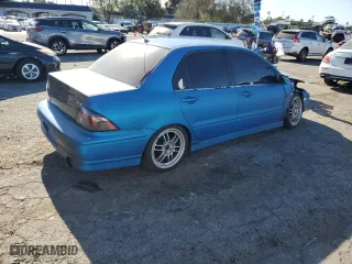 2002 Mitsubishi Lancer OZ-Rally with VIN JA3AJ86E62U070034, listed as a Copart auction lot 86914144 with 180,675 mi miles and Salvage Title. Bid and sale history available at carsss.com. Image 3.