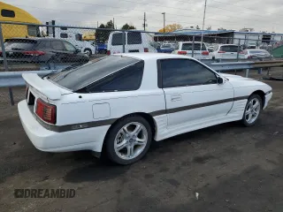 1987 Toyota Supra z VIN JT2MA70L2H0044216, wystawiony jako Copart lot #78864694 z przebiegiem 143 418 mil mil oraz Czysty tytuł • Clean title. Historia ofert i sprzedaży dostępna na DreamBid. Obrazek 3.