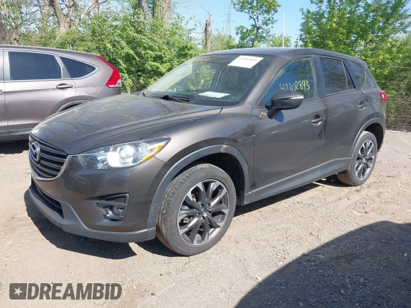 2016 Mazda CX-5 Grand Touring z VIN JM3KE4DY8G0846265, wystawiony jako IAAI lot #42102843 z przebiegiem 159 827 mil mil oraz . Historia ofert i sprzedaży dostępna na DreamBid. Obrazek 2.
