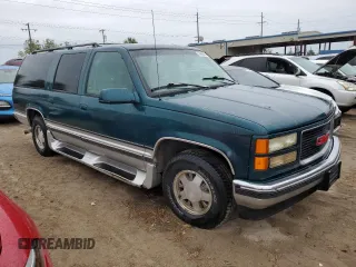 1996 GMC Suburban z VIN 1GKEC16R2TJ714191, wystawiony jako Copart lot #74660264 z przebiegiem 186 801 mil mil oraz Szkody całkowita. Historia ofert i sprzedaży dostępna na DreamBid. Obrazek 4.