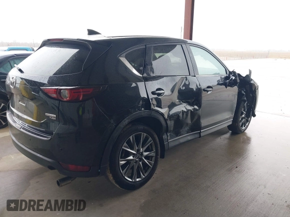 2021 Mazda CX-5 Signature with VIN JM3KFBEY5M0432033, listed as a IAAI auction lot 41607215 with 49,870 mi miles. Bid and sale history available at carsss.com. Image 4.