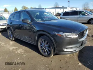 2019 Mazda CX-5 Grand Touring with VIN JM3KFBDM0K0571806, listed as a Copart auction lot 43395105 with 57,768 mi miles and Salvage Title. Bid and sale history available at carsss.com. Image 4.