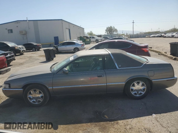 1998 Cadillac Eldorado z VIN 1G6EL12YXWU610918, wystawiony jako Copart lot #57309075 z przebiegiem 168 228 mil mil oraz Szkoda całkowita • Salvage title. Historia ofert i sprzedaży dostępna na DreamBid. Obrazek 1.