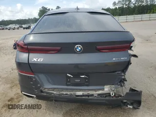 2020 BMW X6 xDrive40i z VIN 5UXCY6C03L9B94299, wystawiony jako Copart lot #53857965 z przebiegiem 54 133 mil mil oraz Szkody całkowita. Historia ofert i sprzedaży dostępna na DreamBid. Obrazek 6.