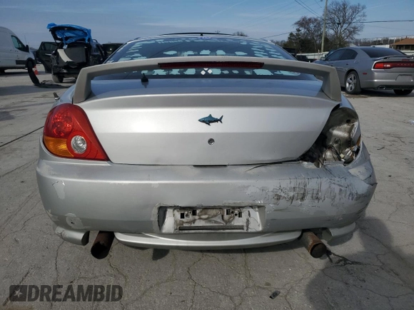 2003 Hyundai Tiburon GT z VIN KMHHN65F13U102985, wystawiony jako Copart lot #45294325 z przebiegiem 326 919 mil mil oraz Szkoda całkowita • Salvage title. Historia ofert i sprzedaży dostępna na DreamBid. Obrazek 6.