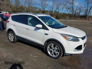 2014 Ford Escape Titanium with VIN 1FMCU9JX7EUD17335, listed as a IAAI auction lot 41302107 with 104,352 mi miles and . Bid and sale history available at DreamBid. Image 1.