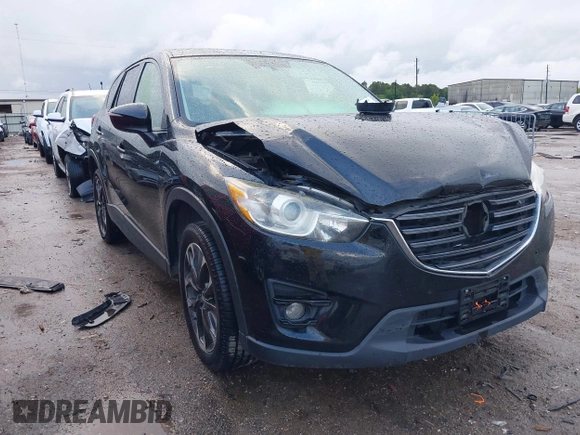 2016 Mazda CX-5 Grand Touring z VIN JM3KE4DY9G0605489, wystawiony jako IAAI lot #42085160 z przebiegiem 160 338 mil mil oraz . Historia ofert i sprzedaży dostępna na DreamBid. Obrazek 1.
