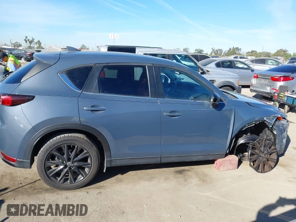 2021 Mazda CX-5 Touring with VIN JM3KFBCM9M0434433, listed as a IAAI auction lot 41425112 with 57,527 mi miles. Bid and sale history available at carsss.com. Image 14.