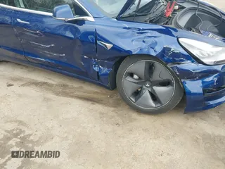 2019 Tesla Model 3 Mid Range with VIN 5YJ3E1EA5KF299589, listed as a IAAI auction lot 41709733 with 50,256 mi miles and . Bid and sale history available at DreamBid. Image 6.