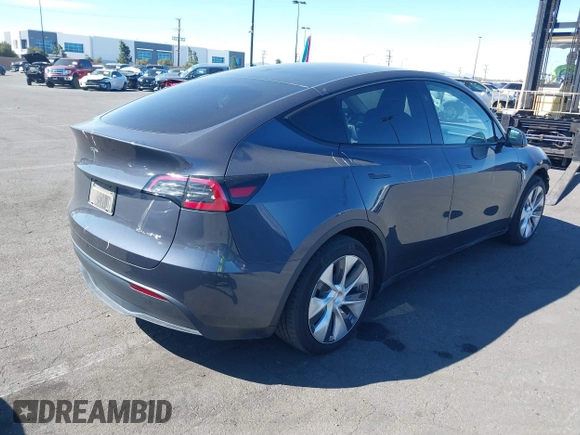 2023 Tesla Model Y Long Range with VIN 7SAYGAEE8PF976969, listed as a IAAI auction lot 41877784 with 25,896 mi miles. Bid and sale history available at carsss.com. Image 4.