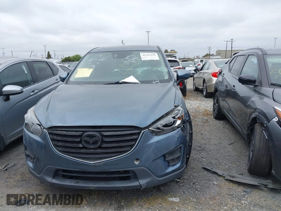 2016 Mazda CX-5 Touring z VIN JM3KE2CY2G0699138, wystawiony jako IAAI lot #42153228 z przebiegiem 144 191 mil mil oraz . Historia ofert i sprzedaży dostępna na DreamBid. Obrazek 12.