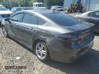 2016 Ford Fusion SE Hybrid z VIN 3FA6P0LU3GR173886, wystawiony jako Copart lot #60066015 z przebiegiem 140 328 mil mil oraz Szkoda całkowita • Salvage title. Historia ofert i sprzedaży dostępna na DreamBid. Obrazek 2.