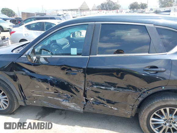 2017 Mazda CX-5 Touring with VIN JM3KFACL0H0124632, listed as a IAAI auction lot 42134971 with 107,029 mi miles and . Bid and sale history available at carsss.com. Image 14.