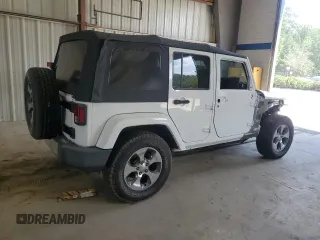 2016 Jeep Wrangler Unlimited Sahara with VIN 1C4BJWEGXGL310499, listed as a Copart auction lot 59756015 with 128,498 mi miles and Salvage title. Bid and sale history available at DreamBid. Image 3.