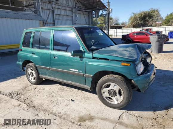1996 Geo Tracker z VIN 2CNBE1363T6921541, wystawiony jako Copart lot #81647384 z przebiegiem 61 806 mil mil oraz Szkoda całkowita • Salvage title. Historia ofert i sprzedaży dostępna na DreamBid. Obrazek 4.