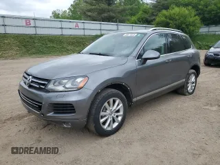 2014 Volkswagen Touareg Sport z VIN WVGEF9BPXED006404, wystawiony jako Copart lot #58671075 z przebiegiem 144 790 mil mil oraz Czysty tytuł • Clean title. Historia ofert i sprzedaży dostępna na DreamBid. Obrazek 1.
