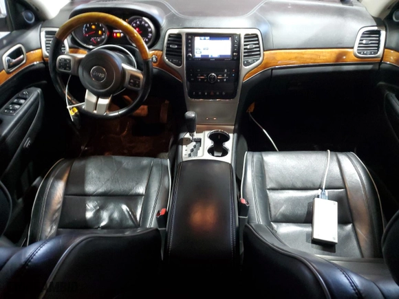 2012 Jeep Grand Cherokee Overland with VIN 1C4RJFCT8CC171384, listed as a Copart auction lot 48164355 with 213,848 mi miles and Salvage Title. Bid and sale history available at carsss.com. Image 8.