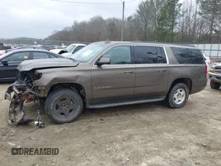 2015 Chevrolet Suburban LT z VIN 1GNSCJKC6FR675585, wystawiony jako IAAI lot #41510570 z przebiegiem 156 818 mil mil oraz . Historia ofert i sprzedaży dostępna na DreamBid. Obrazek 13.