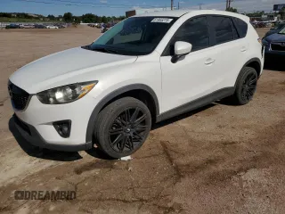 2014 Mazda CX-5 Touring with VIN JM3KE2CY3E0374401, listed as a Copart auction lot 61965275 with 104,212 mi miles and Salvage title. Bid and sale history available at DreamBid. Image 1.