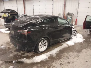 2024 Tesla Model Y Long Range with VIN 7SAYGDEEXRF085795, listed as a IAAI auction lot 41609867 with 57,049 mi miles. Bid and sale history available at carsss.com. Image 4.