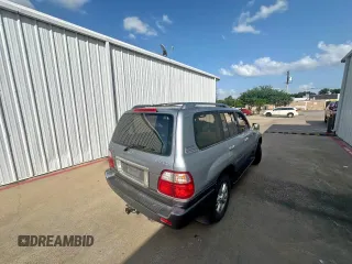 2003 Lexus LX 470 z VIN JTJHT00W933535214, wystawiony jako Copart lot #62037495 z przebiegiem 373 210 mil mil oraz Czysty tytuł • Clean title. Historia ofert i sprzedaży dostępna na DreamBid. Obrazek 4.