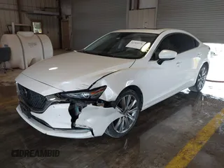 2021 Mazda 6 Carbon Edition with VIN JM1GL1WY9M1614117, listed as a IAAI auction lot 41305576 with 54,670 mi miles and . Bid and sale history available at DreamBid. Image 18.