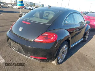 2012 Volkswagen Beetle 2.5L w/Sound/Nav PZEV with VIN 3VWJP7AT7CM661055, listed as a IAAI auction lot 41980159 with 113,678 mi miles and . Bid and sale history available at DreamBid. Image 4.