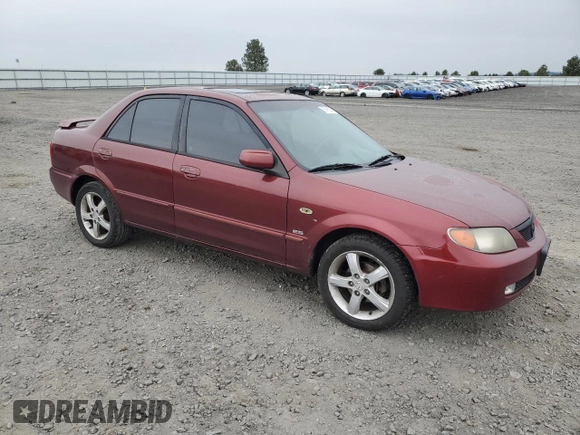 2002 Mazda Protege DX z VIN JM1BJ225320636991, wystawiony jako Copart lot #57915265 z przebiegiem 123 371 mil mil oraz Szkoda całkowita • Salvage title. Historia ofert i sprzedaży dostępna na DreamBid. Obrazek 4.