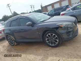 2016 Mazda CX-5 Grand Touring z VIN JM3KE2DY5G0801238, wystawiony jako IAAI lot #42264694 z przebiegiem 136 993 mil mil oraz . Historia ofert i sprzedaży dostępna na DreamBid. Obrazek 12.