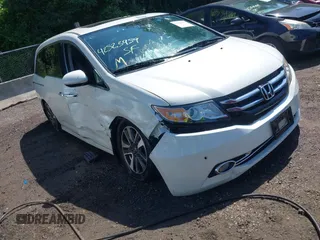 2014 Honda Odyssey Touring with VIN 5FNRL5H94EB071788, listed as a IAAI auction lot 42523959 with 244,734 mi miles and . Bid and sale history available at DreamBid. Image 1.