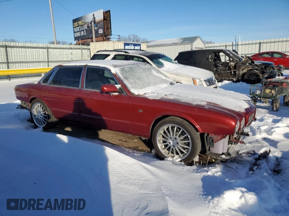1999 Jaguar XJ with VIN SAJPD1841XC869913, listed as a Copart auction lot 41449445 with Not provided miles and Salvage title. Bid and sale history available at DreamBid. Image 4.