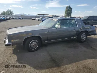 1985 Cadillac Eldorado z VIN 1G6EL5786FE628861, wystawiony jako Copart lot #76372384 z przebiegiem 15 146 mil mil oraz Szkody całkowita. Historia ofert i sprzedaży dostępna na DreamBid. Obrazek 1.