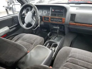1997 Jeep Grand Cherokee Laredo with VIN 1J4GZ58S0VC771727, listed as a Copart auction lot 82233224 with 320,213 mi miles and Salvage Title. Bid and sale history available at carsss.com. Image 8.