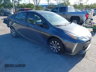 2021 Toyota Prius LE z VIN JTDL9MFU6M3026191, wystawiony jako IAAI lot #41962542 z przebiegiem 164 558 mil mil oraz . Historia ofert i sprzedaży dostępna na DreamBid. Obrazek 1.