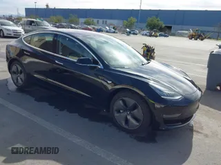 2019 Tesla Model 3 Mid Range with VIN 5YJ3E1EA2KF305834, listed as a IAAI auction lot 41719610 with 126,333 mi miles and . Bid and sale history available at DreamBid. Image 1.