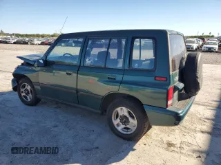 1996 Geo Tracker z VIN 2CNBE1363T6921541, wystawiony jako Copart lot #81647384 z przebiegiem 61 806 mil mil oraz Szkody całkowita. Historia ofert i sprzedaży dostępna na DreamBid. Obrazek 2.