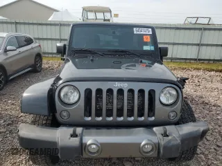 2015 Jeep Wrangler Unlimited Freedom with VIN 1C4BJWDG4FL568601, listed as a Copart auction lot 64041415 with 128,874 mi miles and Salvage title. Bid and sale history available at DreamBid. Image 5.